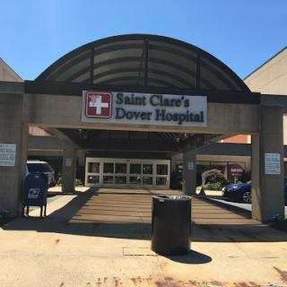 The entrance of a healthcare facility, specifically known as First Clare's Dover Hospital.