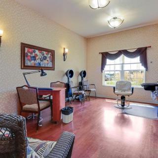 A well-lit hair salon with styling chairs, mirrors, and decor.