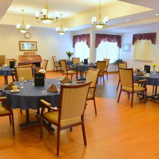 Elegant dining room with tables and chairs set for service.