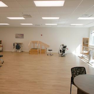 A bright and spacious therapy room designed for rehabilitation exercises.