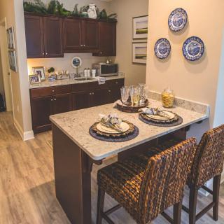 Cozy kitchen area with a countertop dining setup and decorative plates on the wall.