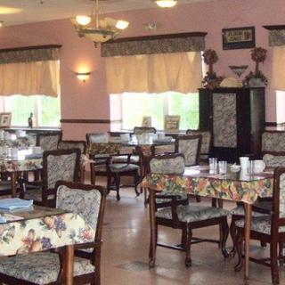 An empty dining room with elegantly set tables and classic decor.