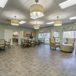 A modern lounge area with ample seating, large windows, and contemporary lighting.