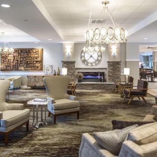 Elegant hotel lobby with comfortable seating and a modern fireplace.