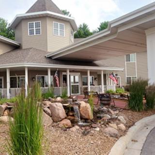 A building entrance with a landscaped area featuring rocks and plants.