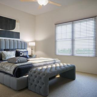 A modern bedroom with stylish furnishings and ample natural light.