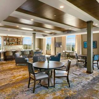 A modern and spacious lounge area with comfortable seating and natural light.