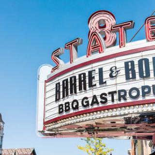 The iconic marquee of Barrel & Bone BBQ Gastropub under a clear blue sky.