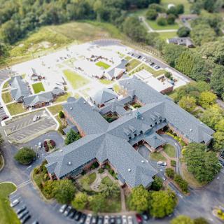 Aerial view of a modern community center surrounded by lush greenery.