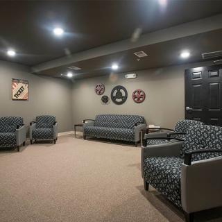 A cozy seating area with modern furniture and wall decor.