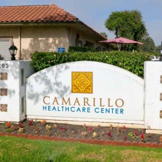 A sign for Camarillo Healthcare Center outside a building.