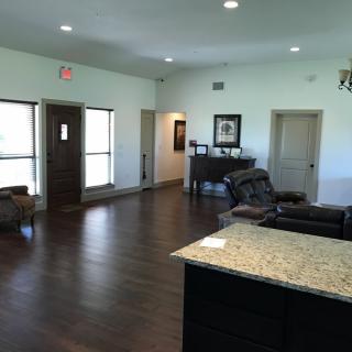 A spacious living room with hardwood floors and modern furnishings.
