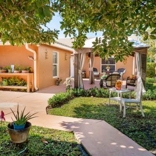 A cozy backyard with a patio, lush greenery, and comfortable outdoor seating.