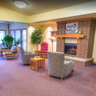 A cozy living room with comfortable seating and a warm fireplace.