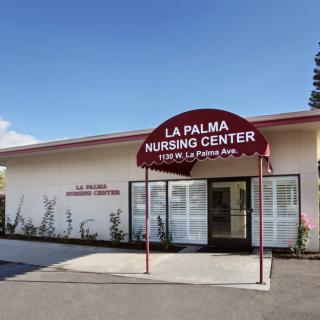 The entrance of La Palma Nursing Center with a red awning.
