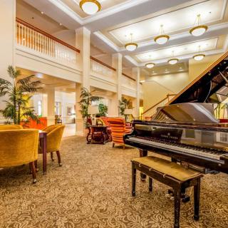 A luxurious lobby with elegant seating and a grand piano.