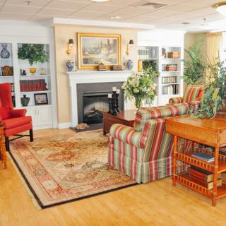 A cozy living room with a fireplace, colorful furniture, and various decorations.