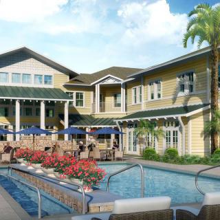 A residential building with an outdoor swimming pool and landscaped surroundings.