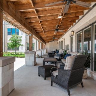 A spacious patio with comfortable seating and ceiling fans, offering a relaxing outdoor space.