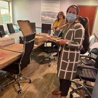 Team members enjoying a meal during a meeting.
