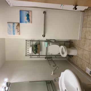 A clean and well-organized bathroom with accessibility features.
