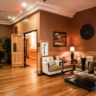 A cozy and elegant lobby with comfortable seating, warm lighting, and decorative artwork.
