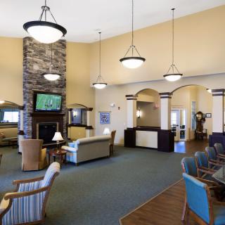 A spacious lobby with comfortable seating and modern lighting fixtures.