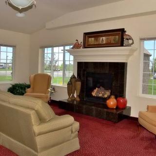 A cozy living room with a fireplace and comfortable seating.
