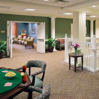 A cozy lounge area with comfortable seating and a card table.