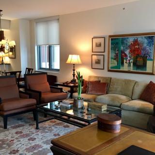 A cozy living room with elegant furniture and vibrant artwork.