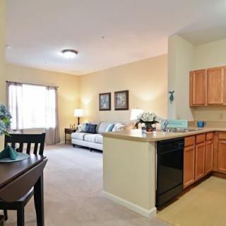 An open-layout apartment with a cozy living room and a kitchen area.