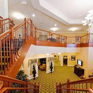 A spacious hotel lobby with a grand staircase and elegant decor.