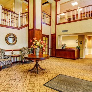 Spacious hotel lobby with elegant decor and a reception desk.