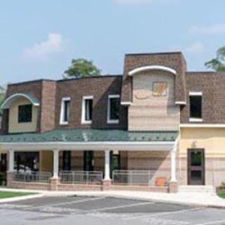 A modern commercial building showcasing a mix of brick and stucco design.