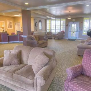 A cozy lobby with sofas and armchairs in a well-lit reception area.