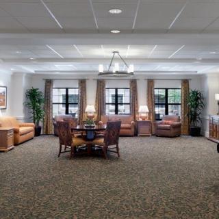 A spacious and well-lit living room with comfortable seating and elegant decor.