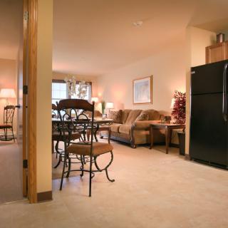 Cozy open-plan living space with kitchen, dining, and seating areas.