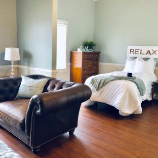 A cozy bedroom with a comfortable sofa, single bed, and relaxing atmosphere.