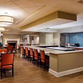A modern dining and bar area with elegant seating and lighting.
