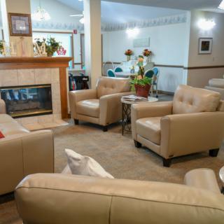 A cozy living room with comfortable armchairs and a fireplace.