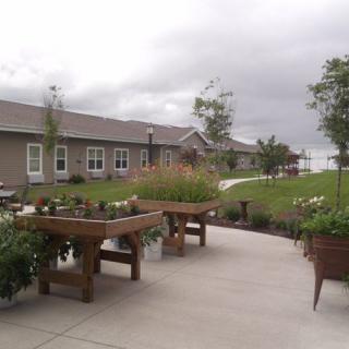 A landscaped outdoor area with raised garden beds and a pathway.