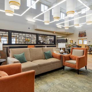A contemporary lounge area featuring comfortable seating and modern lighting.