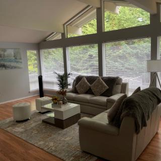A modern living room with large windows letting in natural light.