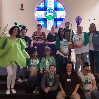 A lively group dressed in creative costumes gathered at the church for a fun event.