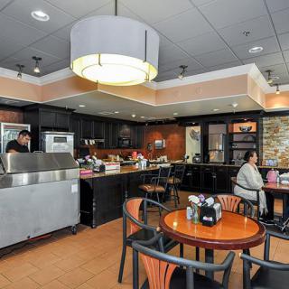 A cozy cafe interior with seating and customers enjoying their time.