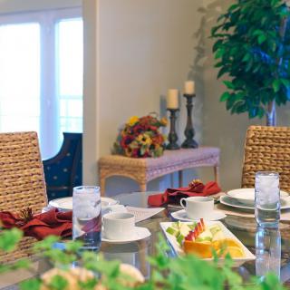 A beautifully set dining table with elegant place settings and decorative elements in a cozy dining room.
