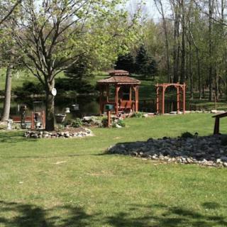 A serene garden setting featuring a gazebo and lush greenery.