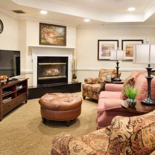 A cozy living room with a fireplace and comfortable seating arrangement.