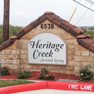 A stone sign for Heritage Creek Assisted Living with the address number 6538.