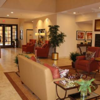 A well-furnished lobby featuring comfortable seating and decorative elements.